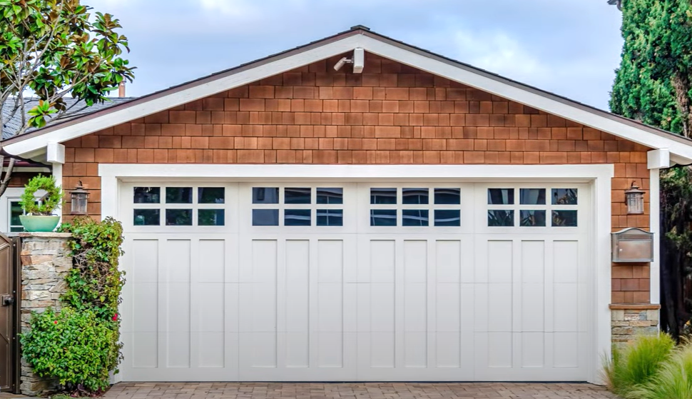 Professional technician performing garage door repair on a residential property