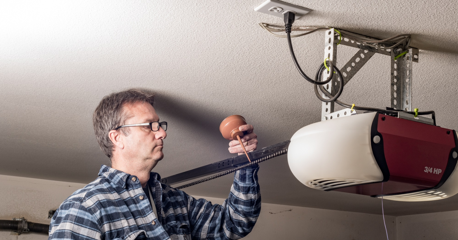 Lubricating the strings of garage door opener.
