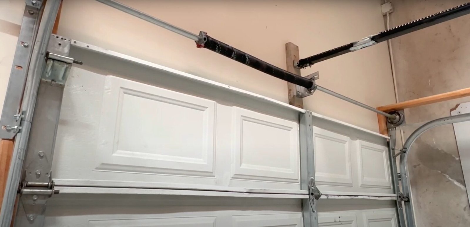 Lubricating garage door spring to fix noisy garage door.
