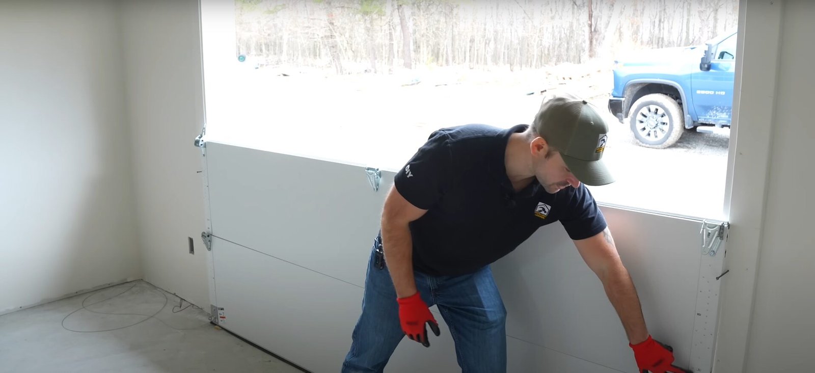 A skilled technician from Powell Garage Door Repair working on a garage door spring replacement, ensuring safety and precision