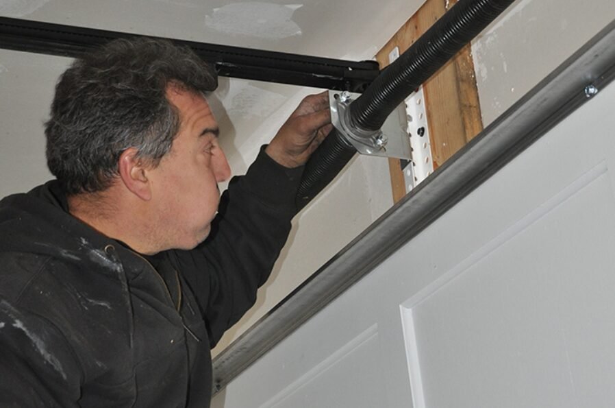 Close-up image of a broken garage door spring needing repair at Powell Garage Door Repair